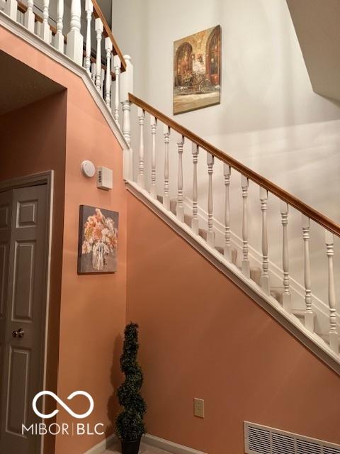 8002 Windham Lake Way Unit 33, Indianapolis, IN 46214 - staircase with baseboards