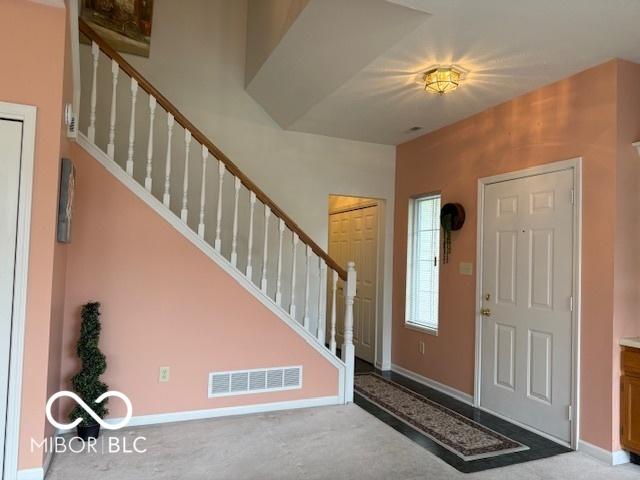 8002 Windham Lake Way Unit 33, Indianapolis, IN 46214 - carpeted entryway with stairs and baseboards