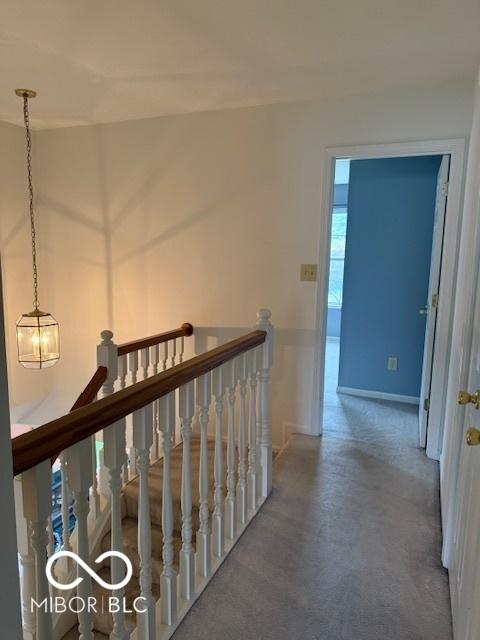 8002 Windham Lake Way Unit 33, Indianapolis, IN 46214 - corridor with an upstairs landing and baseboards