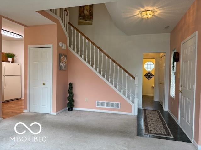 8002 Windham Lake Way Unit 33, Indianapolis, IN 46214 - entryway featuring stairway, carpet flooring, and baseboards