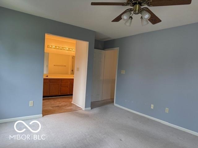 8002 Windham Lake Way Unit 33, Indianapolis, IN 46214 - unfurnished bedroom with carpet flooring, baseboards, and connected bathroom