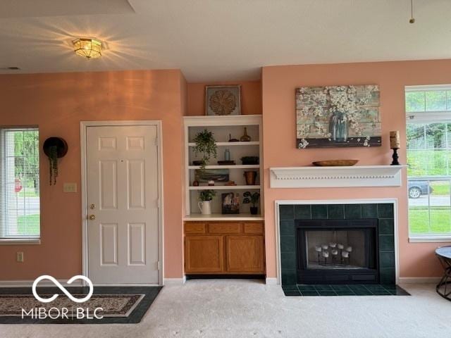 8002 Windham Lake Way Unit 33, Indianapolis, IN 46214 - living room with a tiled fireplace, carpet floors, and baseboards