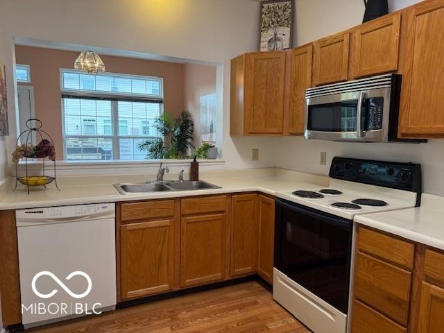 8002 Windham Lake Way Unit 33, Indianapolis, IN 46214 - kitchen featuring range with electric stovetop, dishwasher, stainless steel microwave, a sink, and light countertops