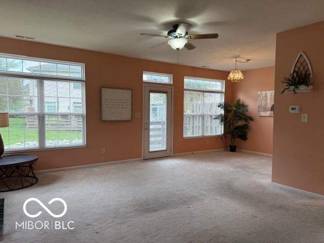 8002 Windham Lake Way Unit 33, Indianapolis, IN 46214 - carpeted foyer featuring ceiling fan, baseboards, and a chandelier