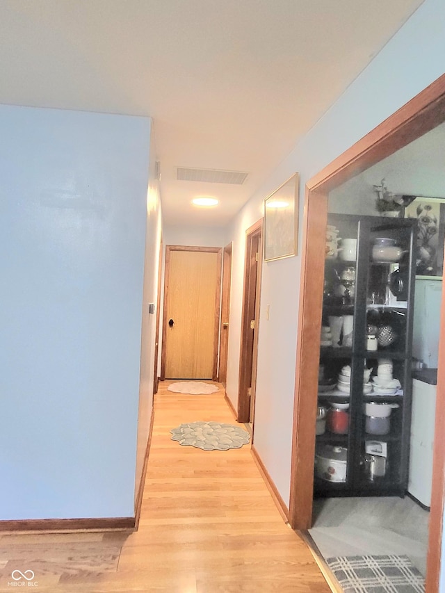 7109 Chandler Dr, Indianapolis, IN 46217 - corridor featuring baseboards, visible vents, and light wood-style floors