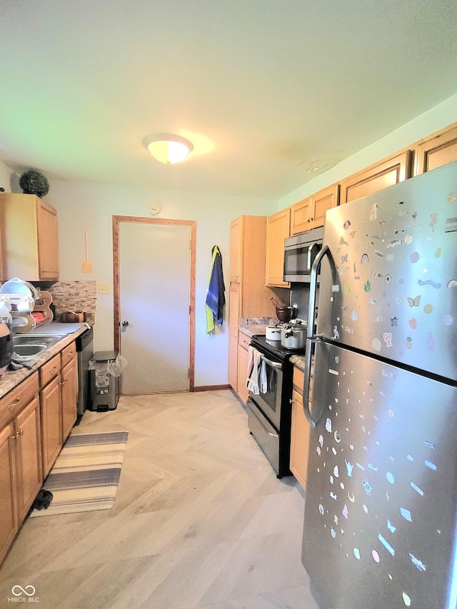 7109 Chandler Dr, Indianapolis, IN 46217 - kitchen with a sink, light brown cabinets, light countertops, appliances with stainless steel finishes, and tasteful backsplash