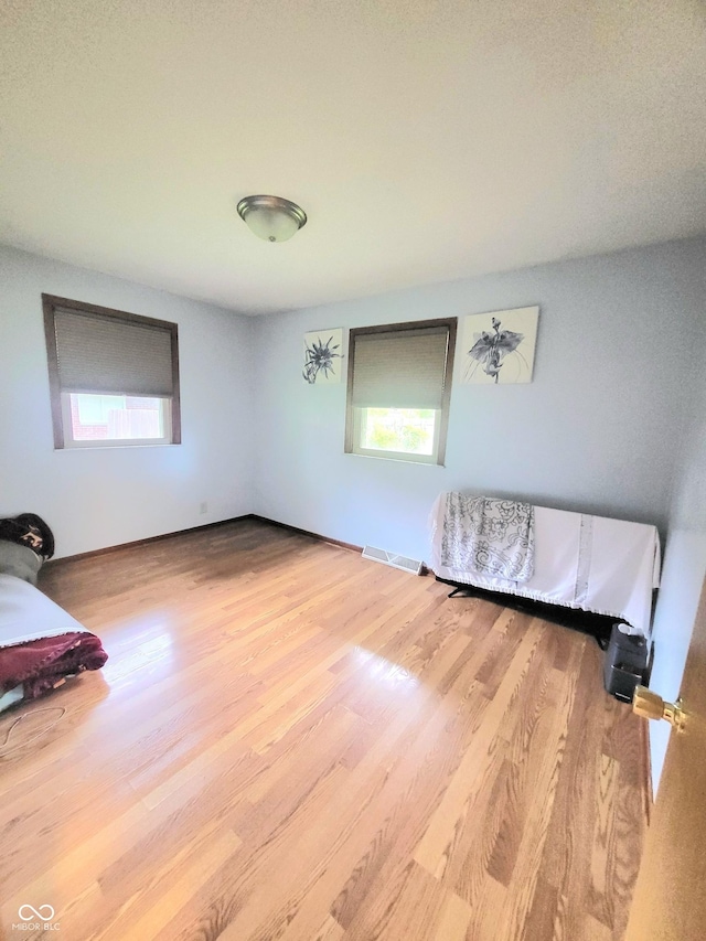 7109 Chandler Dr, Indianapolis, IN 46217 - unfurnished bedroom featuring visible vents and wood finished floors