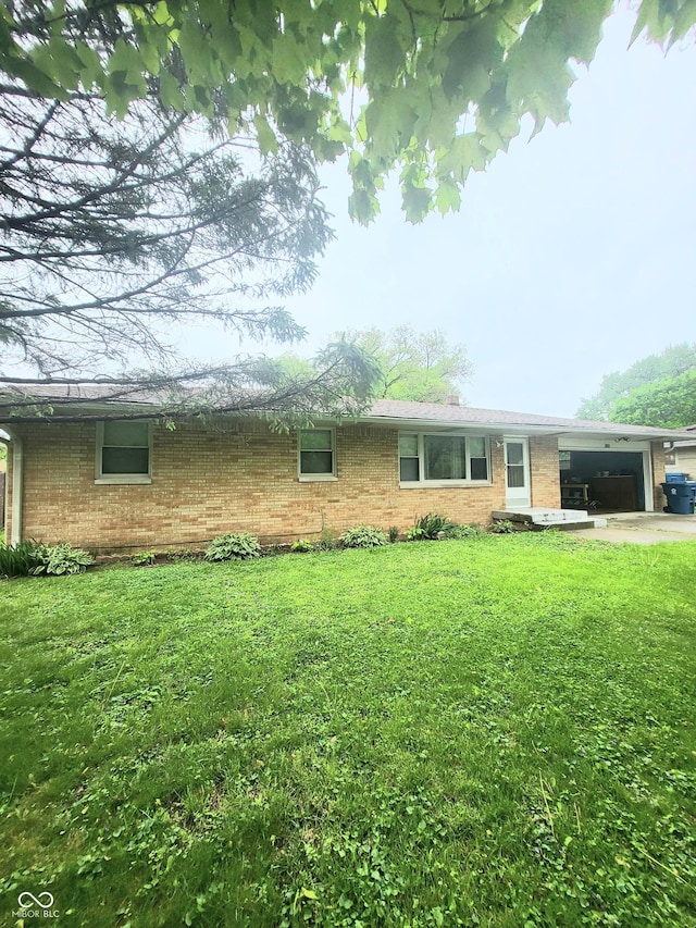 7109 Chandler Dr, Indianapolis, IN 46217 - single story home featuring a garage, a front lawn, and brick siding