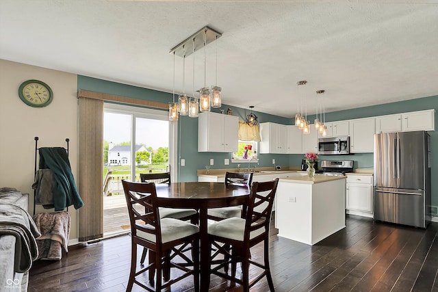 6624 Lakestone Ct, Indianapolis, IN 46237 - dining space featuring healthy amount of natural light, dark wood-type flooring, a textured ceiling, and a chandelier