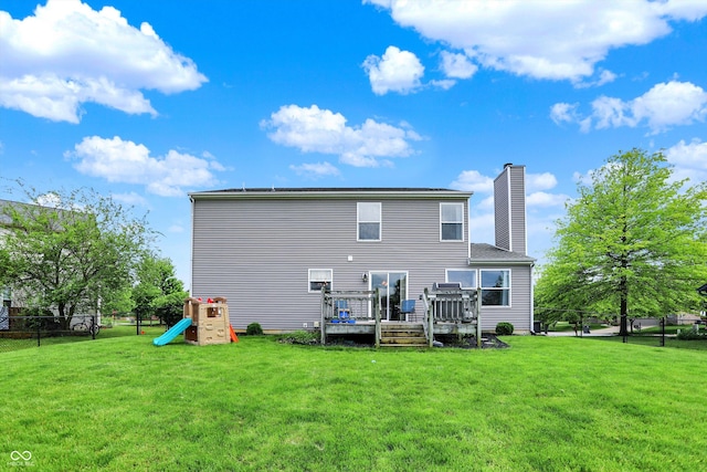 6624 Lakestone Ct, Indianapolis, IN 46237 - back of property featuring a chimney, a wooden deck, and a playground
