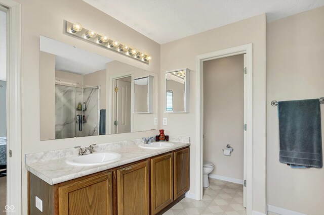 6624 Lakestone Ct, Indianapolis, IN 46237 - bathroom with a stall shower, toilet, tile patterned floors, double vanity, and baseboards