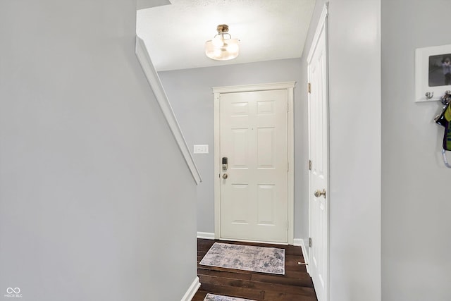 6624 Lakestone Ct, Indianapolis, IN 46237 - doorway featuring dark wood-style flooring and baseboards