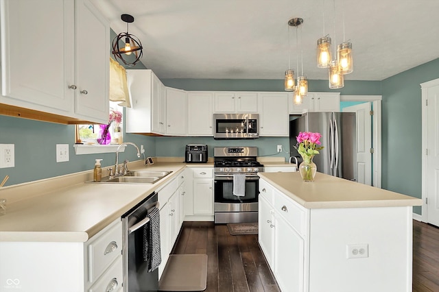 6624 Lakestone Ct, Indianapolis, IN 46237 - kitchen with appliances with stainless steel finishes, a sink, dark wood-type flooring, and a kitchen island