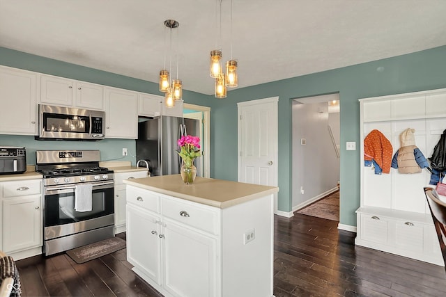 6624 Lakestone Ct, Indianapolis, IN 46237 - kitchen with appliances with stainless steel finishes, dark wood-style floors, light countertops, and white cabinets