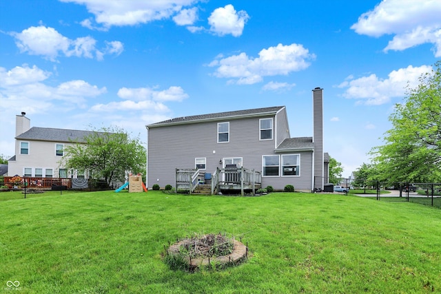 6624 Lakestone Ct, Indianapolis, IN 46237 - back of property with a chimney, a wooden deck, and a playground