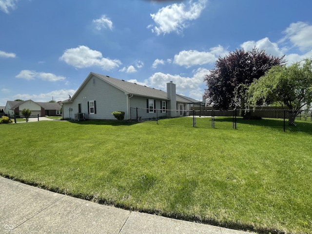 8234 Crosser Dr, Indianapolis, IN 46237 - view of side of home with a yard, a chimney, cooling unit, and fence