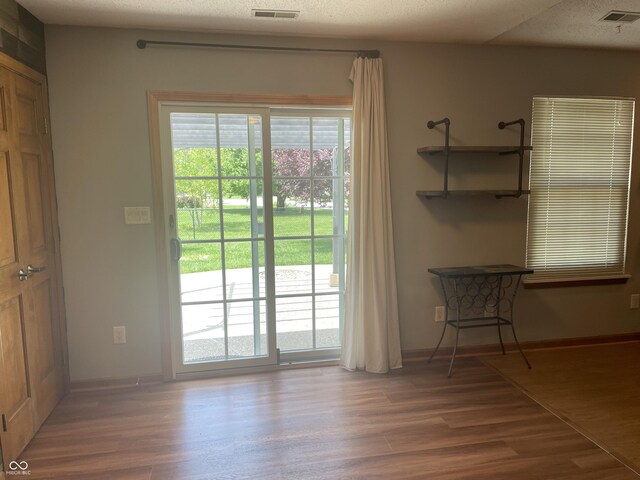 8234 Crosser Dr, Indianapolis, IN 46237 - doorway with baseboards, visible vents, and wood finished floors