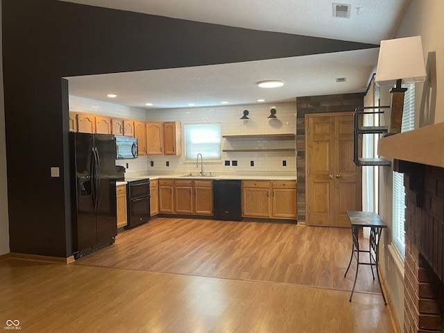 8234 Crosser Dr, Indianapolis, IN 46237 - kitchen with light wood-style flooring, a sink, visible vents, black appliances, and light countertops