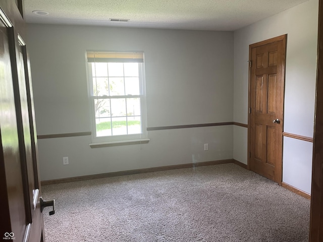 8234 Crosser Dr, Indianapolis, IN 46237 - empty room with carpet, a textured ceiling, visible vents, and baseboards