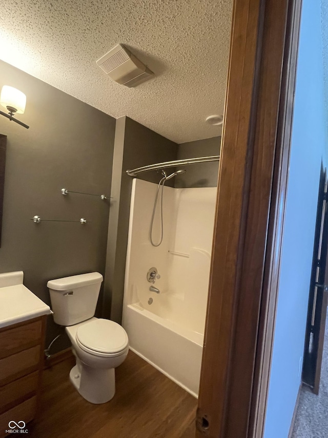 8234 Crosser Dr, Indianapolis, IN 46237 - bathroom featuring toilet, wood finished floors, vanity, a textured ceiling, and visible vents