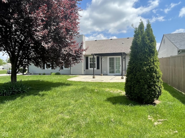 8234 Crosser Dr, Indianapolis, IN 46237 - back of house featuring roof with shingles, a patio area, fence, a yard, and a chimney