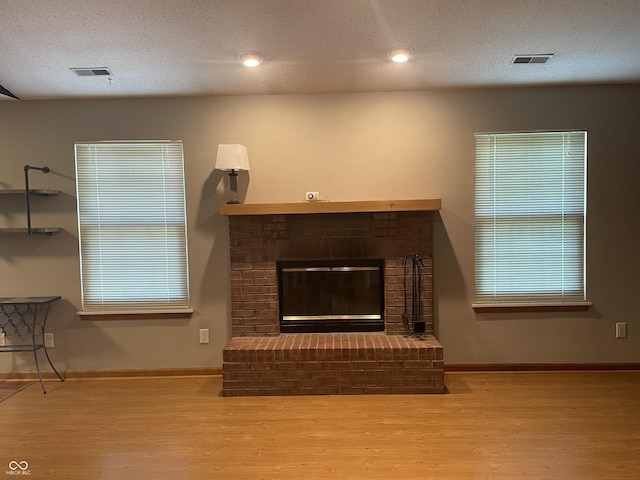 8234 Crosser Dr, Indianapolis, IN 46237 - unfurnished living room with baseboards, a fireplace, visible vents, and wood finished floors