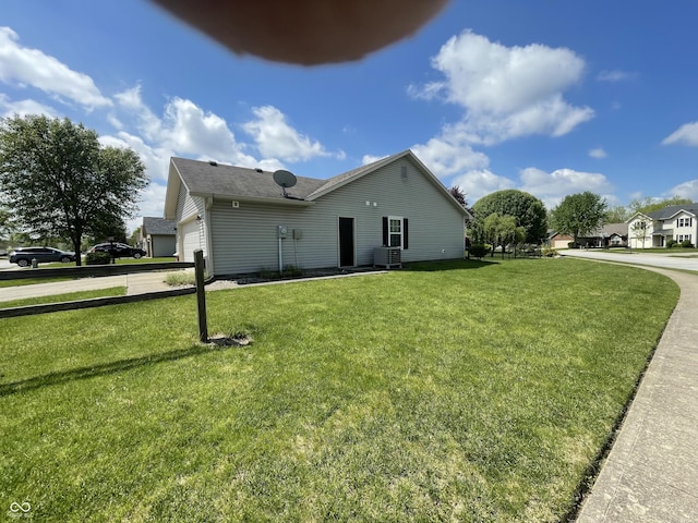 8234 Crosser Dr, Indianapolis, IN 46237 - exterior space with a yard, driveway, an attached garage, central air condition unit, and a shingled roof
