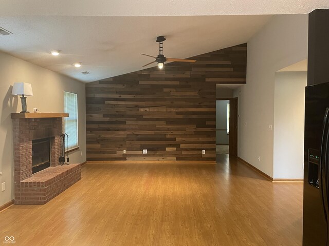 8234 Crosser Dr, Indianapolis, IN 46237 - unfurnished living room with wood walls, wood finished floors, lofted ceiling, and ceiling fan