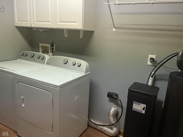 8234 Crosser Dr, Indianapolis, IN 46237 - laundry room featuring washing machine and clothes dryer, cabinet space, and wood finished floors
