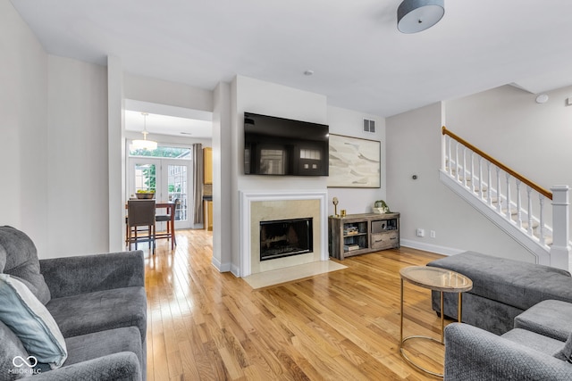 952 Junction Pl, Indianapolis, IN 46220 - living room featuring light wood-style flooring, stairway, a fireplace, and baseboards
