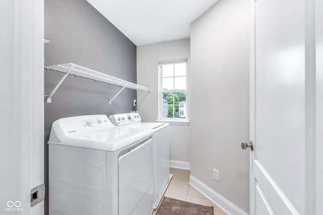 952 Junction Pl, Indianapolis, IN 46220 - washroom featuring washing machine and clothes dryer, baseboards, and light tile patterned flooring