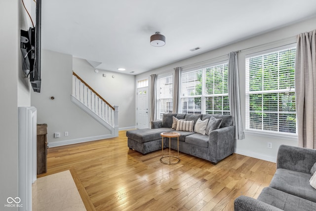 952 Junction Pl, Indianapolis, IN 46220 - living room with stairway, light wood-style flooring, baseboards, and healthy amount of natural light