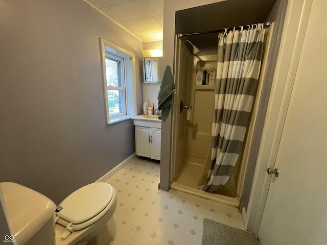 bathroom with toilet, vanity, ornamental molding, tile patterned floors, and a stall shower