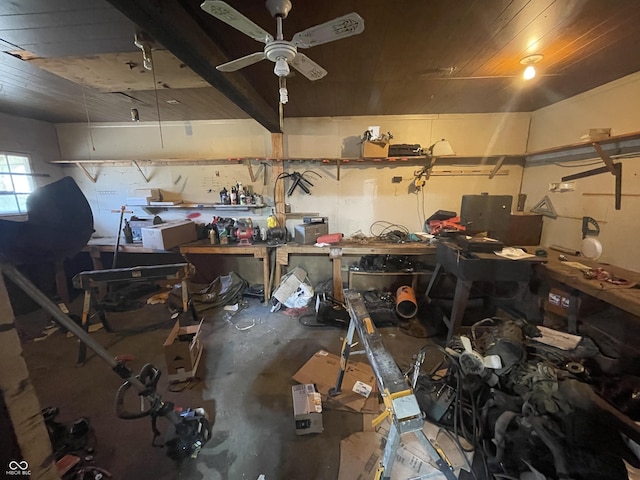 garage featuring a workshop area, wood ceiling, and a ceiling fan