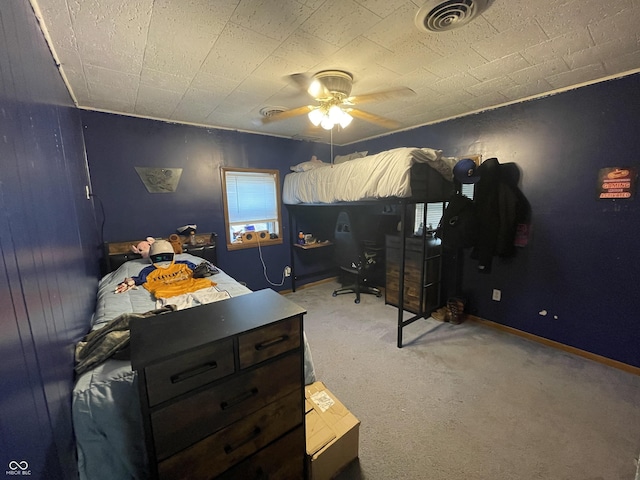 carpeted bedroom with visible vents and a ceiling fan