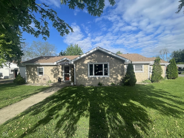 view of front of property with a front lawn and concrete block siding
