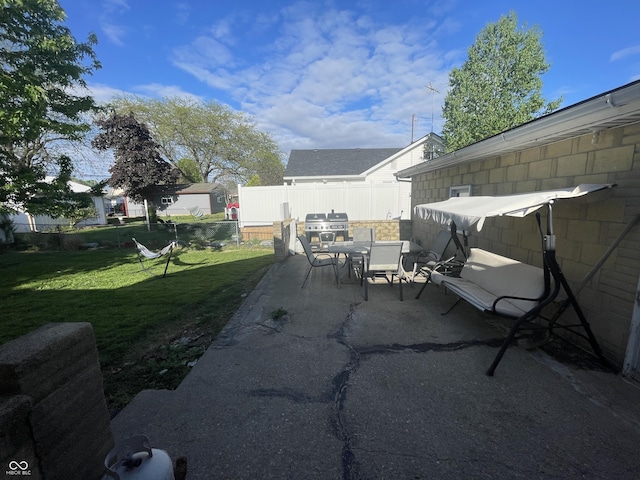 view of patio featuring fence and outdoor dining area
