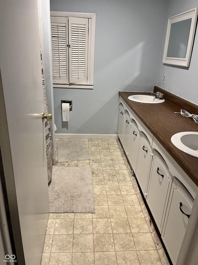 1122 Shelby St, Shelbyville, IN 46176 - bathroom with double vanity and baseboards