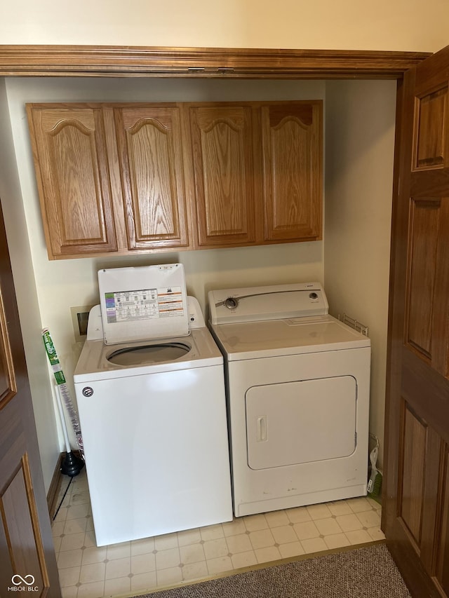 washroom with independent washer and dryer and cabinet space