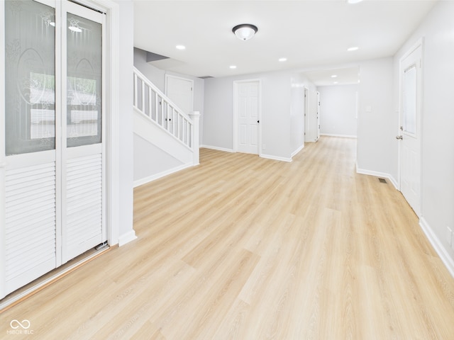 225 S Carthage Rd, Charlottesville, IN 46117 - unfurnished living room with stairs, light wood-type flooring, baseboards, and recessed lighting