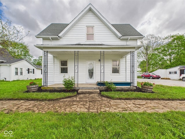 225 S Carthage Rd, Charlottesville, IN 46117 - view of front of property featuring covered porch, a front lawn, and roof with shingles
