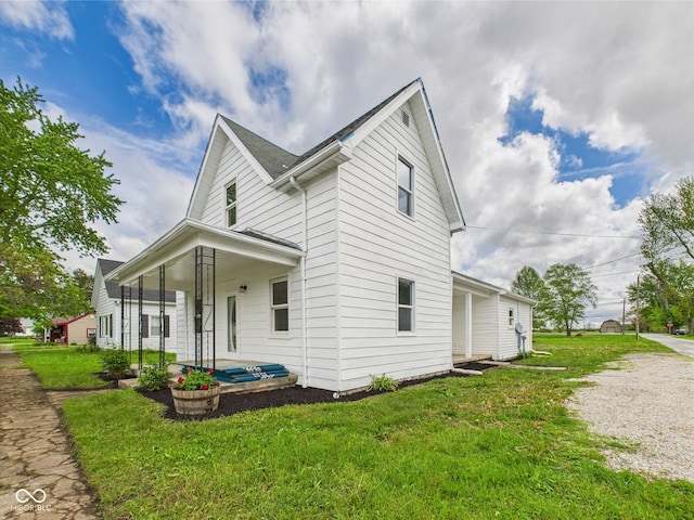 225 S Carthage Rd, Charlottesville, IN 46117 - view of property exterior with a yard and a porch