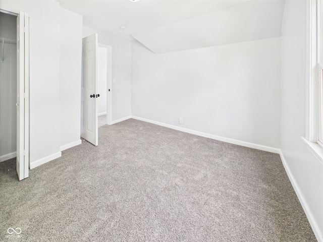 225 S Carthage Rd, Charlottesville, IN 46117 - unfurnished bedroom featuring carpet floors, baseboards, a closet, and lofted ceiling