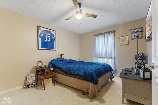 bedroom with light colored carpet, a textured ceiling, ceiling fan, and baseboards