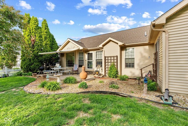 back of property featuring a patio area and roof with shingles