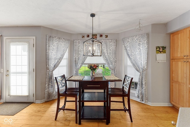 dining space with light wood-style floors and baseboards