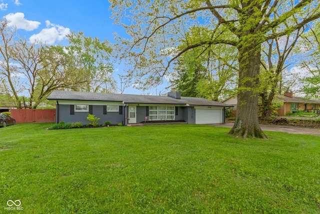 single story home featuring driveway, a garage, and a chimney