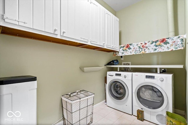 laundry room with independent washer and dryer, cabinet space, baseboards, and light tile patterned flooring