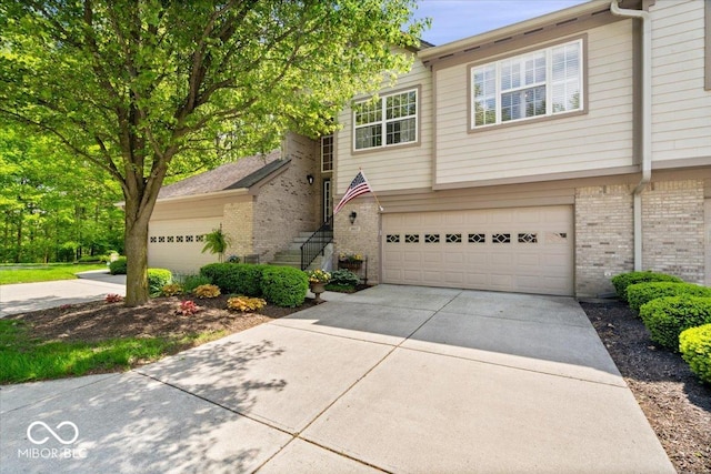 view of front of house with brick siding, concrete driveway, and a garage