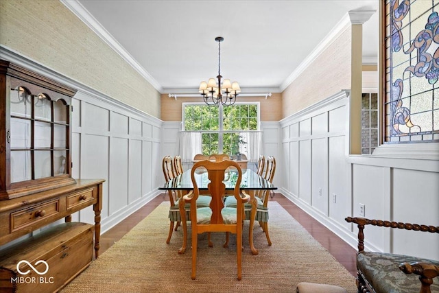 dining area featuring a decorative wall, dark wood-style floors, a chandelier, ornamental molding, and a wainscoted wall